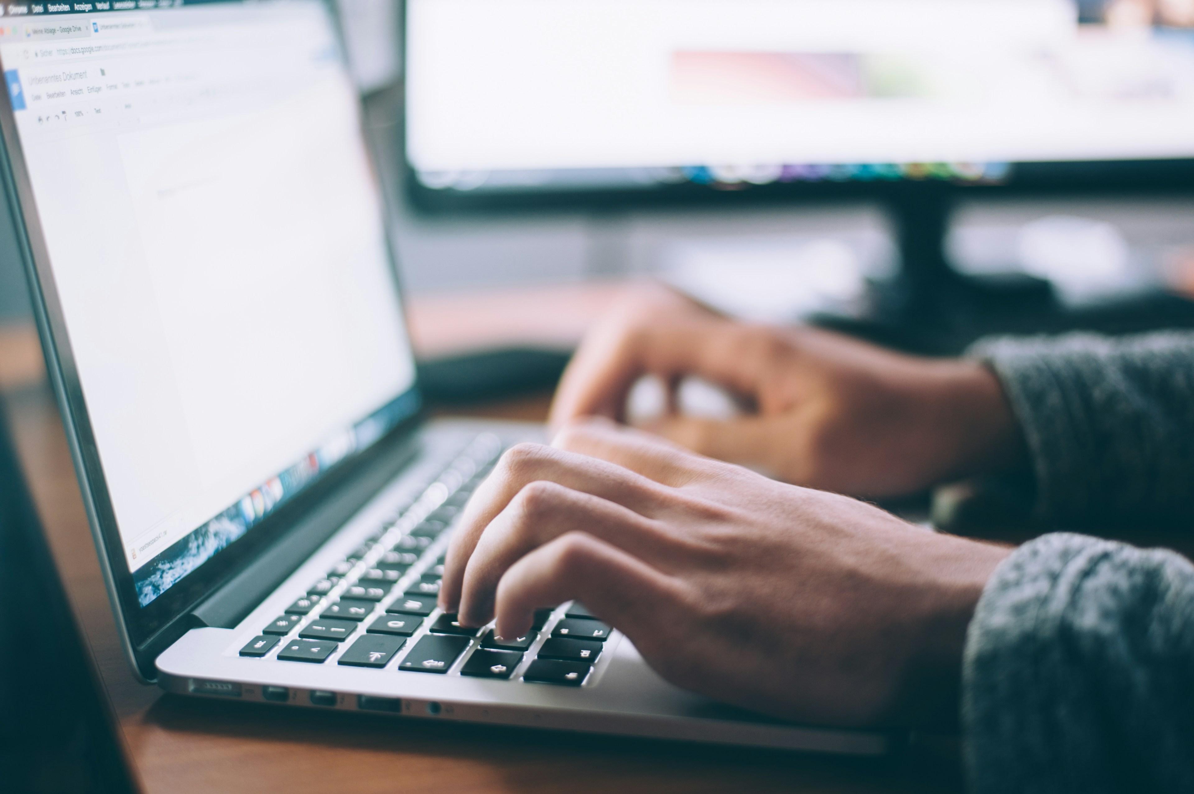 Professional workspace with laptop and learning materials
